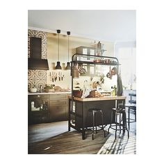 a kitchen with lots of counter space and stools next to an island in the middle