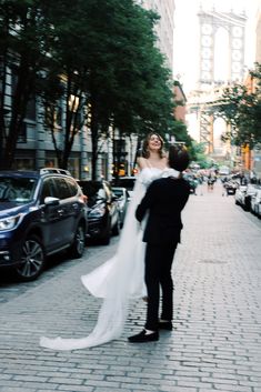 a bride and groom walking down the street