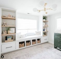 a living room with white walls and shelves filled with books, toys and other items