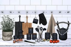 an assortment of kitchen utensils and pots on a white counter top next to a potted plant