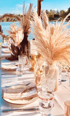 the table is set with place settings and flowers