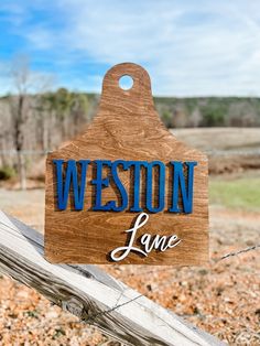 a wooden sign that says weston lane on it