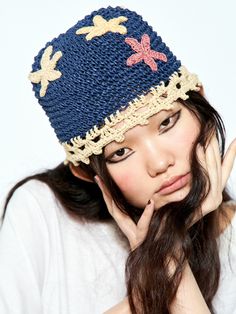 a woman wearing a blue hat with stars on it