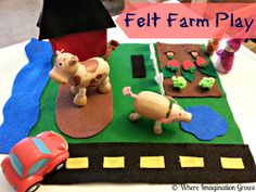 a play mat with farm animals and cars on it that is made out of felt