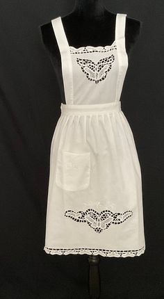 a white dress with an embroidered design on it