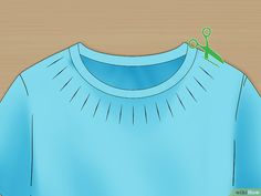 an image of a blue shirt with scissors stuck to the front and back of it