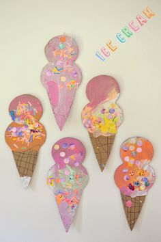 five ice cream cones decorated with sprinkles and confetti