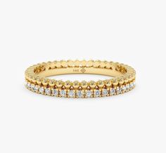 a yellow gold ring with rows of diamonds