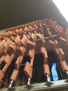 a building that has some kind of structure on it's side and is made out of cardboard boxes