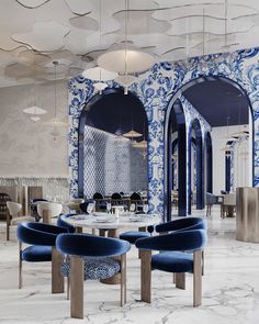 an elegant dining room with blue and white wallpaper