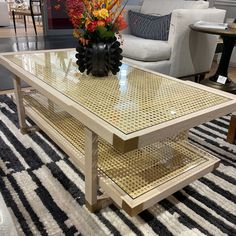 a coffee table sitting on top of a rug next to a couch