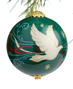 a green ornament with a white dove on it