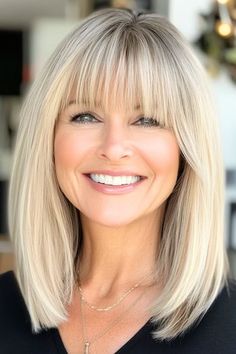 Save this pin for the best medium-length haircuts for women over 60 with bangs. This blonde lob sits perfectly at the collarbone and has wispy bangs that have a lightness that softens the look. This style lets your natural texture peek through while maintaining a refined shape. Shoulder Bob With Side Bangs, Medium Choppy Bob With Bangs, Short Bangs Long Hair Layered Cuts, Medium Length Hair For Oval Face, Mid Length Hair With Wispy Bangs, Wispy Blonde Bangs, Hairstyles Medium Length With Bangs, Over 50 Haircuts Medium Lengths, Medium Length Wispy Bangs