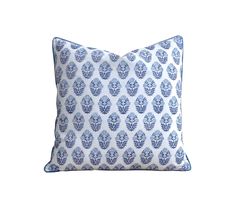 a blue and white pillow on a white background