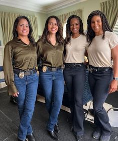 four women in jeans are posing for the camera