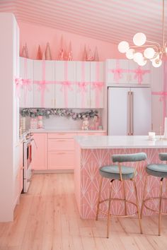 A wallpapered ceiling instantly upgrades a kitchen! Keiko Lynn chose a pink and white striped non-pasted Spoonflower wallpaper for dash of holiday magic. Working with the high, sloped ceilings of her 90s Florida suburban home, Keiko called in the professionals to install this super cute wallpaper. Would you ever wallpaper your ceiling? Find Keiko's favorite wallpapers and find the perfect design for your next home makeover! #Wallpaper #KitchenDesign #HomeDecor