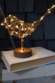 a light up bird sitting on top of a book