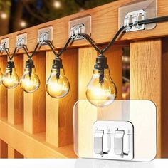 the light bulbs are plugged into the wooden rail with two lights on each side