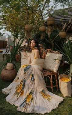 a woman sitting on top of a chair next to plants