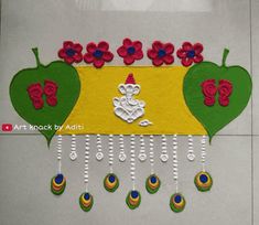 an art work with flowers and hearts on the wall next to beads hanging from hooks