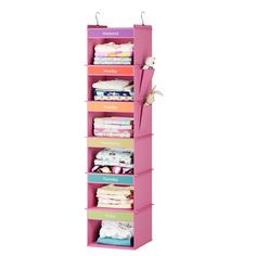 a pink hanging closet with lots of folded clothes on it's sides and four drawers