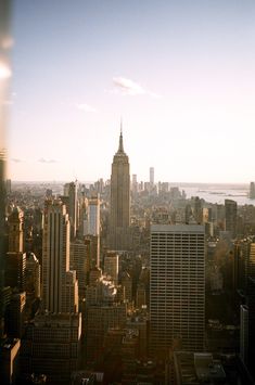 an aerial view of new york city with the empire building in the foreground and the hudson river in the background