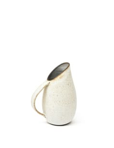 a white and black coffee cup on a white background with the handle extended to it's side