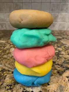 a stack of colorful doughnuts sitting on top of a counter