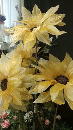 some yellow flowers are in a vase on a table