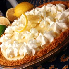 a lemon pie with meringue and marshmallows on the top is ready to be eaten