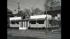 an old black and white photo shows the outside of a restaurant with awnings