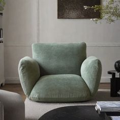 a living room with a green chair in it