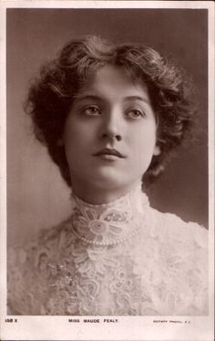 an old black and white photo of a woman wearing a lace collared top with curly hair