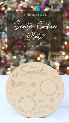 personalized santa coffee mate coaster sitting next to a christmas tree with lights in the background