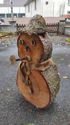 a carved wooden bear with a pipe in its mouth