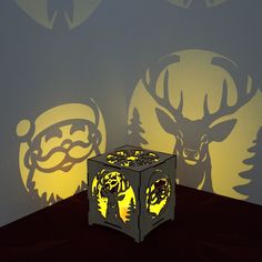 an illuminated cube sitting on top of a table next to a deer head wallpaper