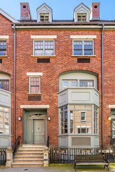 a brick building with many windows and stairs