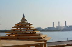 a wooden structure sitting in front of a body of water