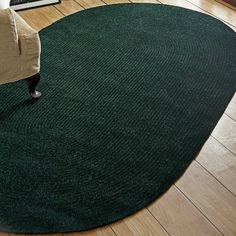 a living room with a green rug on the floor