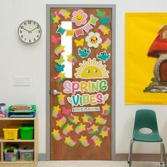 a classroom door decorated with spring vibes stickers next to a book shelf and clock