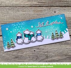 a christmas card with snowmen and trees on it, in front of a wooden background