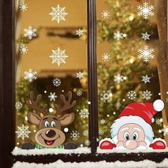 christmas window stickers with santa and reindeer looking out the window