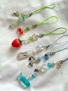 several different necklaces with charms on them