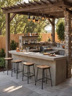 an outdoor bar with stools and lights