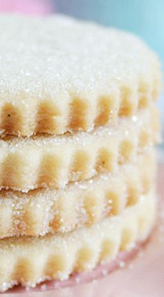 three cookies stacked on top of each other with powdered sugar on the edges and bottom