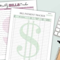 two bills trackers and a calculator on top of a desk