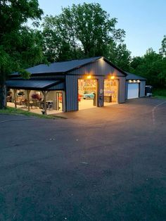 a garage with two cars parked in it and lights on the side of the building