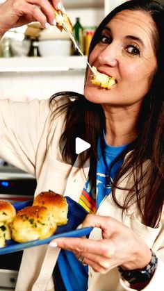 a woman eating food from a blue plate