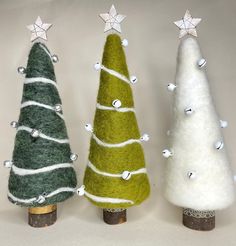 three small christmas trees sitting next to each other