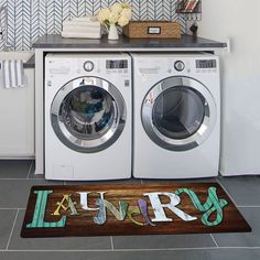 a washer and dryer sitting next to each other in a room with tile flooring